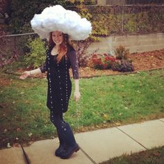 a woman wearing a cloud hat on top of her head