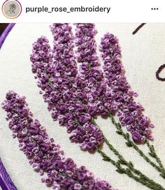 a close up of a purple flower on a white and purple background with the words purple rose embroidery