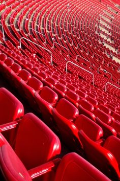 rows of red seats in an empty stadium