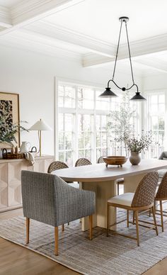 the dining room table is surrounded by chairs and an area rug that has been placed in front of it