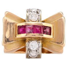 Center Stone: 4 Square Cut Rubies Weight: Approximately .50 Carats Accent Stone: 4 Round Brilliant cut diamonds Weight: Approximately .45 Carats Color: G Clarity: VS Metal: 18K Yellow Gold Era: Retro Circa: 1940's Size: 7.5 and can be resized Gram weight: 11.16 This stunning retro tank ring, crafted in 18K yellow gold, showcases a bold design featuring 4 square cut rubies that total approximately .50 carats. The rich red hue of the rubies is beautifully complemented by 4 round brilliant cut diamonds, which add approximately .45 carats of sparkle, graded G in color and VS in clarity. Weighing 11.16 grams and sized at 7.5, this exquisite piece from the 1940s can be resized for a perfect fit. Its unique and striking design makes it a captivating statement piece for any occasion. Tank Ring, Ruby Diamond, Square Cut, Bold Design, Round Brilliant Cut Diamond, Brilliant Cut Diamond, Cocktail Rings, Rings Statement, Round Brilliant