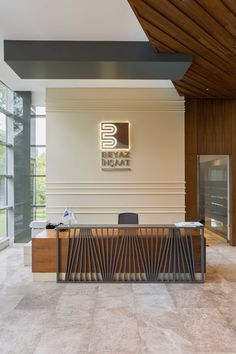 an office lobby with a large wooden desk