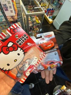 a person holding a hello kitty toy in their hand