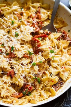 a bowl full of pasta with meat and cheese