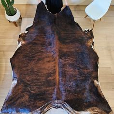 a person standing in front of a cowhide rug