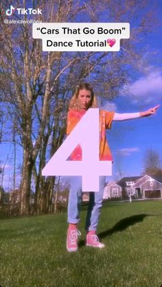 a girl standing in the grass with her arms out and number four written on it