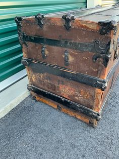 an old trunk is sitting on the ground