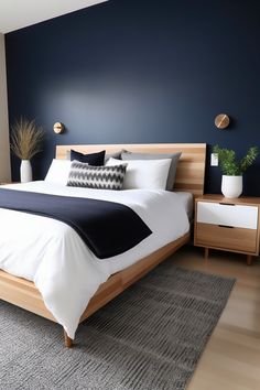 Photographed from an angle that captures the entire king-size bed and most of the room, this modern bedroom features a midnight blue accent wall balanced by light wood tones. A wooden headboard, matching nightstands, and a neutral area rug complete the look.