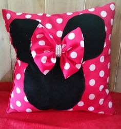 a pink and white pillow with a minnie mouse on it