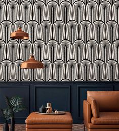 an art deco style wallpaper with black and white designs on it, along with two leather chairs