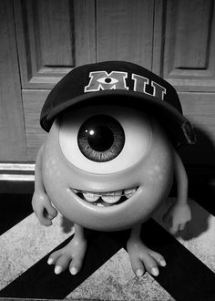 a black and white photo of a cartoon character with big eyes wearing a hat that says exit