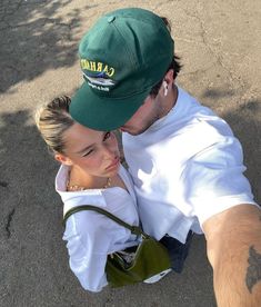 a man and woman taking a selfie in the street