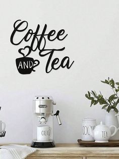 coffee and tea wall decal on a white wall next to a table with cups