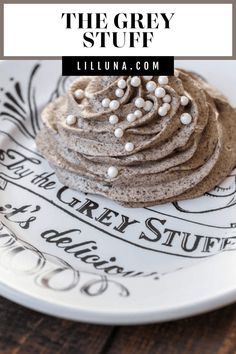 a white plate topped with cookies covered in frosting on top of a wooden table