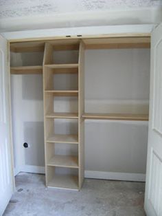 an empty walk in closet with shelves and carpeted flooring on the side wall