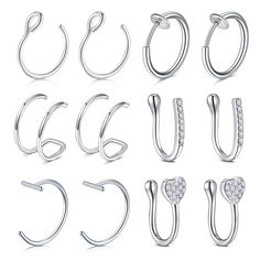 six pairs of silver hoop earrings with crystal stones on each side and one earring in the