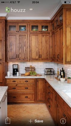 a kitchen with wooden cabinets and marble counter tops on the wall is featured in an ad for houzz