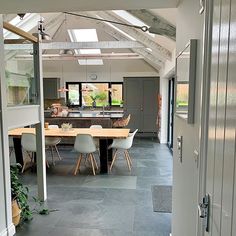 an open kitchen and dining room with skylights