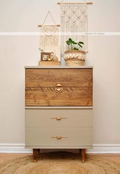 a dresser with two baskets on top of it and a rug in front of it