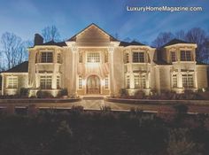 a large white house lit up at night