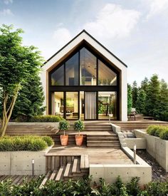 a house that has some plants in front of it and stairs leading up to the door