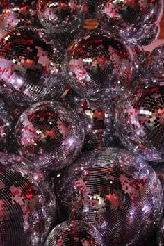 many shiny disco balls are stacked on top of each other