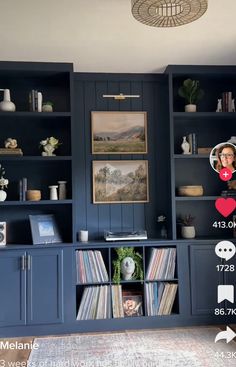 the room is decorated in blue and has shelves with various records on them, including cds