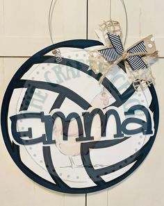 a round sign with the word gym hanging on it's side and two bows attached to it