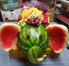 an elephant made out of watermelon, grapes, oranges and melons