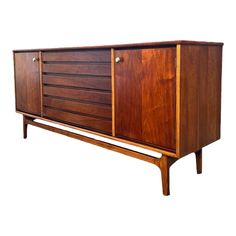 the sideboard is made out of wood and has two doors on one side, and three drawers on the other