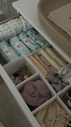 an organized drawer with baby items in it