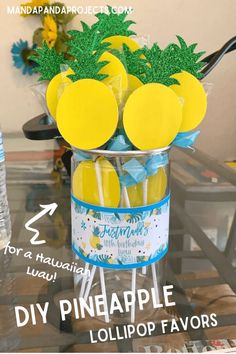 pineapple lollipop favors in a glass vase