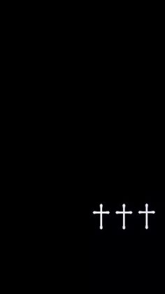 the cross is white in color against a black background with two smaller crosses on it