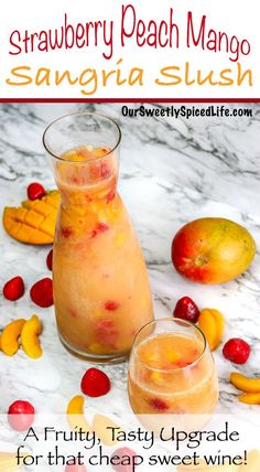 two glasses filled with fruit sitting on top of a marble counter next to some fruit