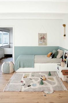 a living room filled with lots of furniture and decor on top of a hard wood floor