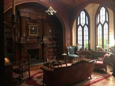 a living room filled with furniture and large windows