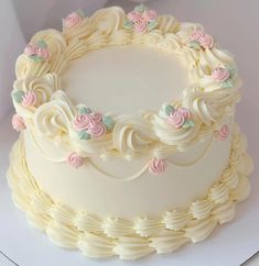 a white cake with pink and green flowers on it