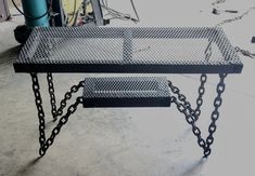 a metal table with chains attached to it