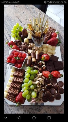 a table topped with lots of different types of snacks and desserts on top of it