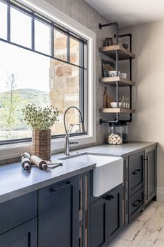 a kitchen sink sitting under a window next to a window