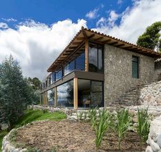 a house on top of a hill with trees in the background