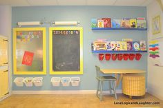 a classroom with blue walls and yellow shelves