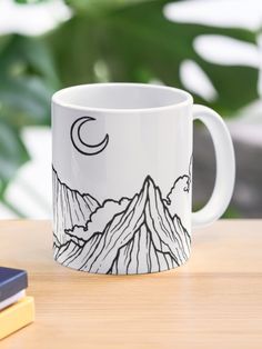 a white coffee mug sitting on top of a wooden table