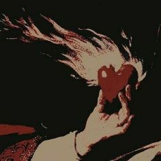 a woman holding a red heart in her right hand