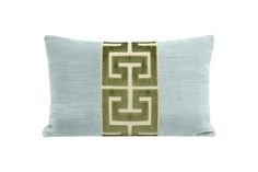 a light blue and green pillow with an intricate design on the front, along with a white background