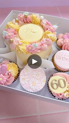 a box filled with lots of cupcakes on top of a table