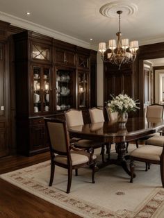 a formal dining room table with chairs and chandelier