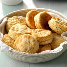 a basket full of biscuits sitting on top of a table