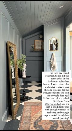 a room with a checkered floor, mirror and rug on the floor in front of it