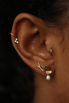 a close up of a person's ear with two different types of piercings